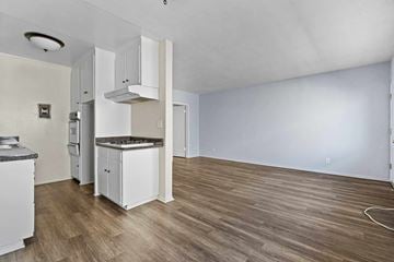 Burbank apartment for rent - A kitchen with white cabinets and a wooden floor.