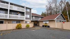 Brentwood Bay apartment for rent - A large apartment complex with a small building in front of it.