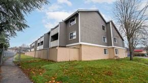 Brentwood Bay apartment for rent - A modern apartment building with a grey and beige exterior.