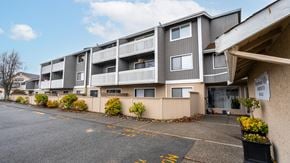 Brentwood Bay apartment for rent - Apartment building with a parking lot in front.