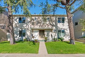 Burbank apartment for rent - A white house with a tree in front.