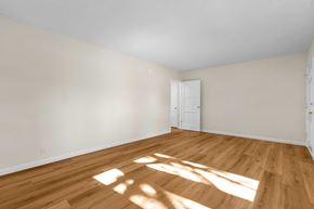 Burbank apartment for rent - A room with wooden floors and white walls.