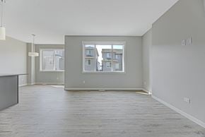 Edmonton apartment for rent - A room with a large window and a view of a building outside.