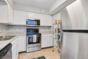 Leavenworth apartment for rent - A kitchen with white cabinets and stainless steel appliances.