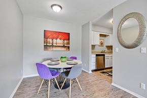 Leavenworth apartment for rent - A dining room with a purple chair and a painting of a red forest scene on the wall.