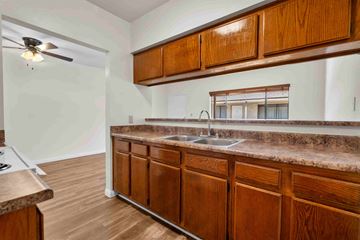 Burbank apartment for rent - A kitchen with wooden cabinets and a marble countertop.