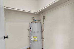 Burbank apartment for rent - A tankless water heater in a room with white walls.