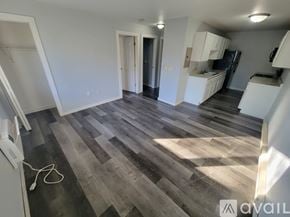 La Crosse apartment for rent - A room with wooden flooring and white walls.
