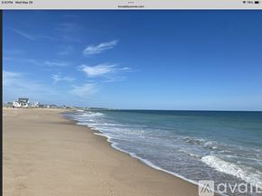 South Kingstown house for rent - A beach with waves coming in from the ocean.