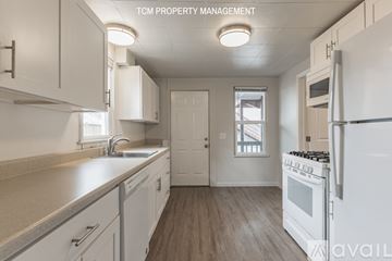 Everett apartment for rent - A kitchen with white cabinets and a white refrigerator.