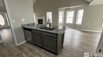 Newnan house for rent - A kitchen with a granite countertop and a sink.