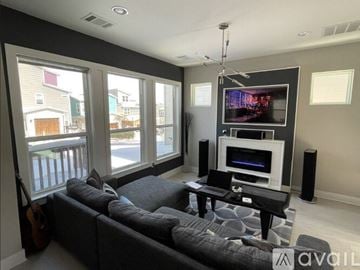 Austin house for rent - A living room with a grey couch and a television.