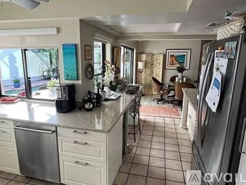 Sarasota house for rent - A kitchen with a refrigerator on the right side.