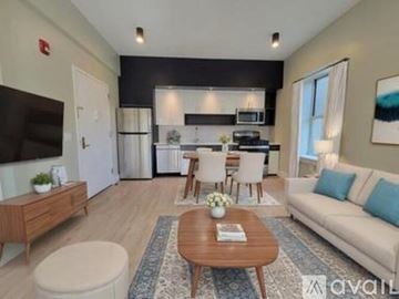 East Orange apartment for rent - A modern living room with a wooden coffee table and a white sofa.