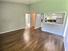 Oklahoma City house for rent - A room with wooden flooring and a mirror on the wall.