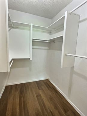 Oklahoma City house for rent - A walk-in closet with white shelves and wooden floors.