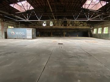 Atlanta apartment for rent - A large empty warehouse with a container labeled "MOL" in the corner.