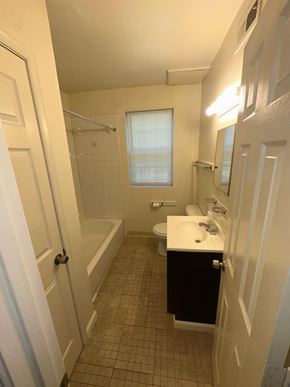 Washington apartment for rent - A bathroom with a white sink and black cabinet.