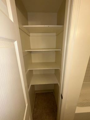 Washington apartment for rent - Empty white shelves in a narrow hallway.