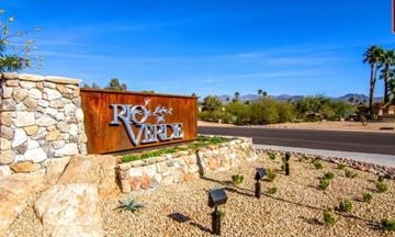 Cottonwood apartment for rent - A sign that says Rio Verde in front of a stone wall.