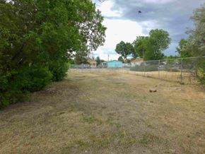 Walsenburg house for rent - A field with a fence and trees in the background.