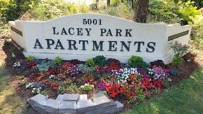 Lacey apartment for rent - A sign for Lacey Park Apartments is surrounded by flowers.