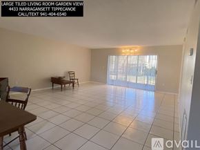 Sarasota condo for rent - A living room with a garden view and a piano.