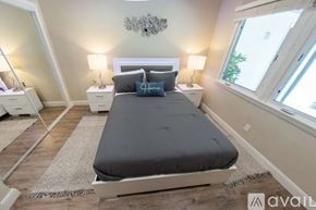 Los Angeles house for rent - A bedroom with a large bed and two nightstands.