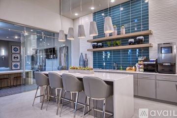 Odessa apartment for rent - A modern kitchen with a bar area and chairs.