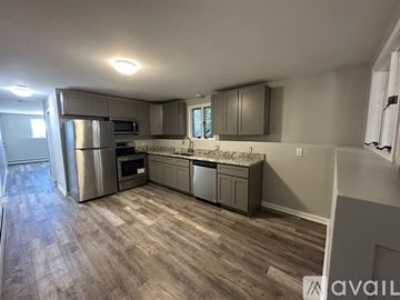 Providence apartment for rent - A kitchen with a refrigerator, oven, and microwave.