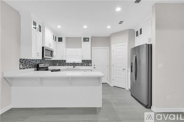Weslaco apartment for rent - A modern kitchen with white cabinets and a large island.