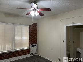 Los Angeles apartment for rent - A room with a ceiling fan and a window with blinds.