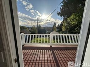 Tacoma townhouse for rent - A view from a doorway looking out to a white fence and a telephone pole.