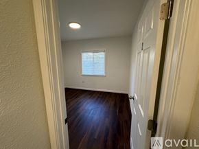 Tacoma townhouse for rent - A hallway with a wooden floor and a white door.