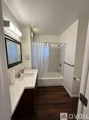 Tacoma townhouse for rent - A bathroom with a white sink and a white tub.