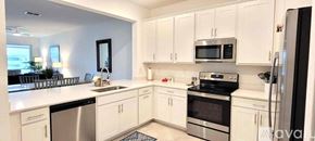 Englewood house for rent - A white kitchen with a fridge on the right.