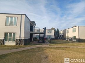 Yukon apartment for rent - A row of houses with a grassy area in front.