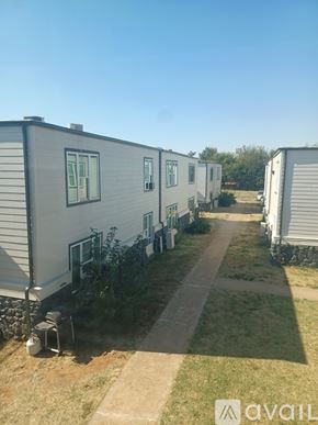 Yukon apartment for rent - A row of mobile homes with a clear blue sky above.
