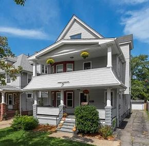 Cleveland apartment for rent - A two-story house with a front porch and a red door.