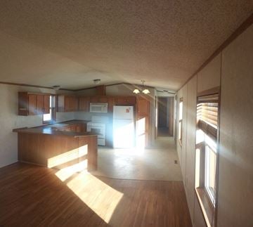 Billings house for rent - A kitchen with wooden cabinets and a microwave.