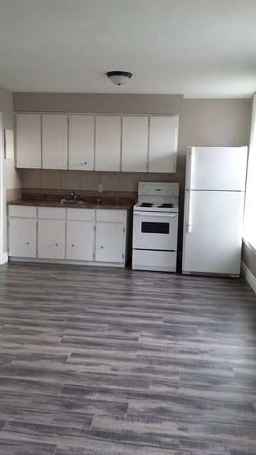 Hamilton apartment for rent - A kitchen with white appliances and cabinets.