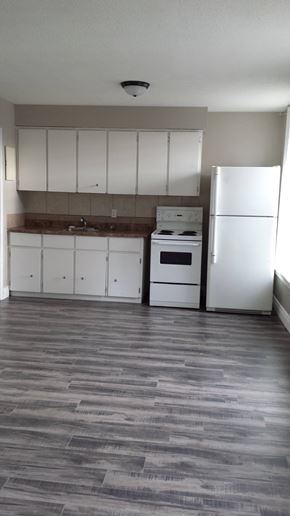 Hamilton apartment for rent - A kitchen with white appliances and cabinets.