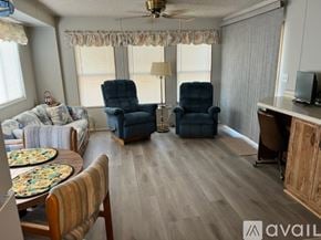 Mesa house for rent - A living room with a sofa, two chairs, a table, and a television.