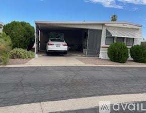 Mesa house for rent - A car is parked in a garage attached to a house.