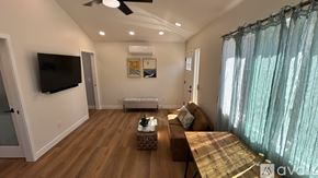 Santa Ana apartment for rent - A living room with a flat screen TV mounted on the wall.