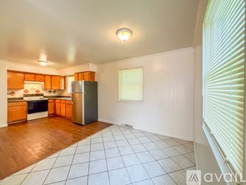 Hopewell house for rent - A kitchen with wooden floors and white walls.