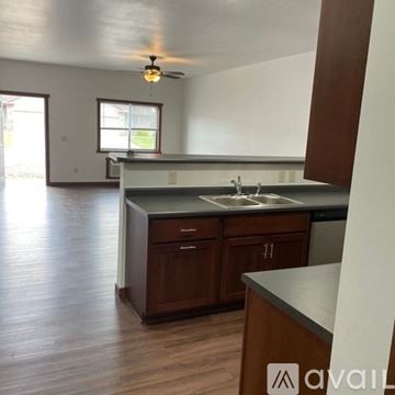 Sparta townhouse for rent - A kitchen with wooden cabinets and a countertop.