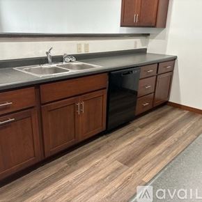 Sparta townhouse for rent - A kitchen with wooden cabinets and a grey countertop.