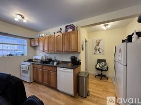 Brookline apartment for rent - A kitchen with wooden cabinets and a white fridge.