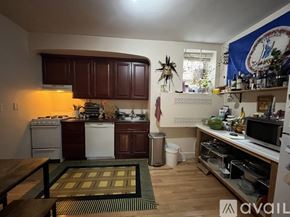 Brookline apartment for rent - A kitchen with wooden cabinets and a white stove top oven.